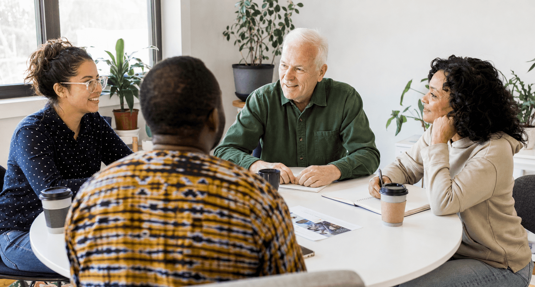 Volunteers planning community support around a table